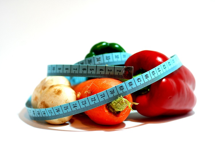 a tape measure wraps around some vegetables