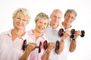 A group of older people lifting weights