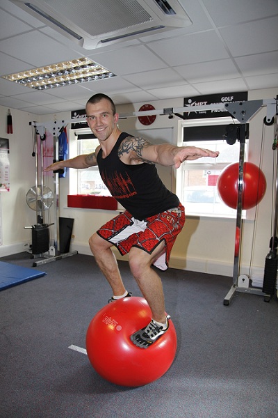 fitness trainer balancing on a stability ball