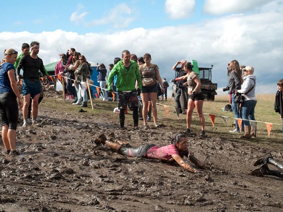 people walking through mud