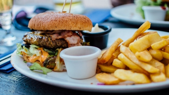 burger and chips on a plate at a resturant