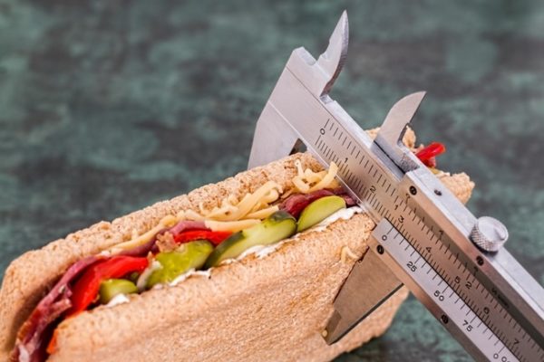 pciture of a measure seeing how big a healthy sandwich is in calories