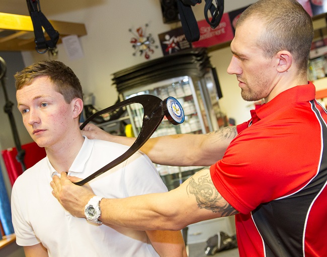 personal trainer assessing a fitness client