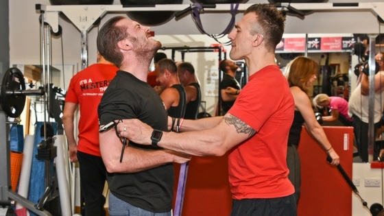 personal training client being pushed hard by a fitness professional in the gym